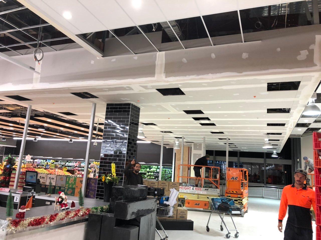 Suspended plasterboard ceiling with recessed lighting in a supermarket
